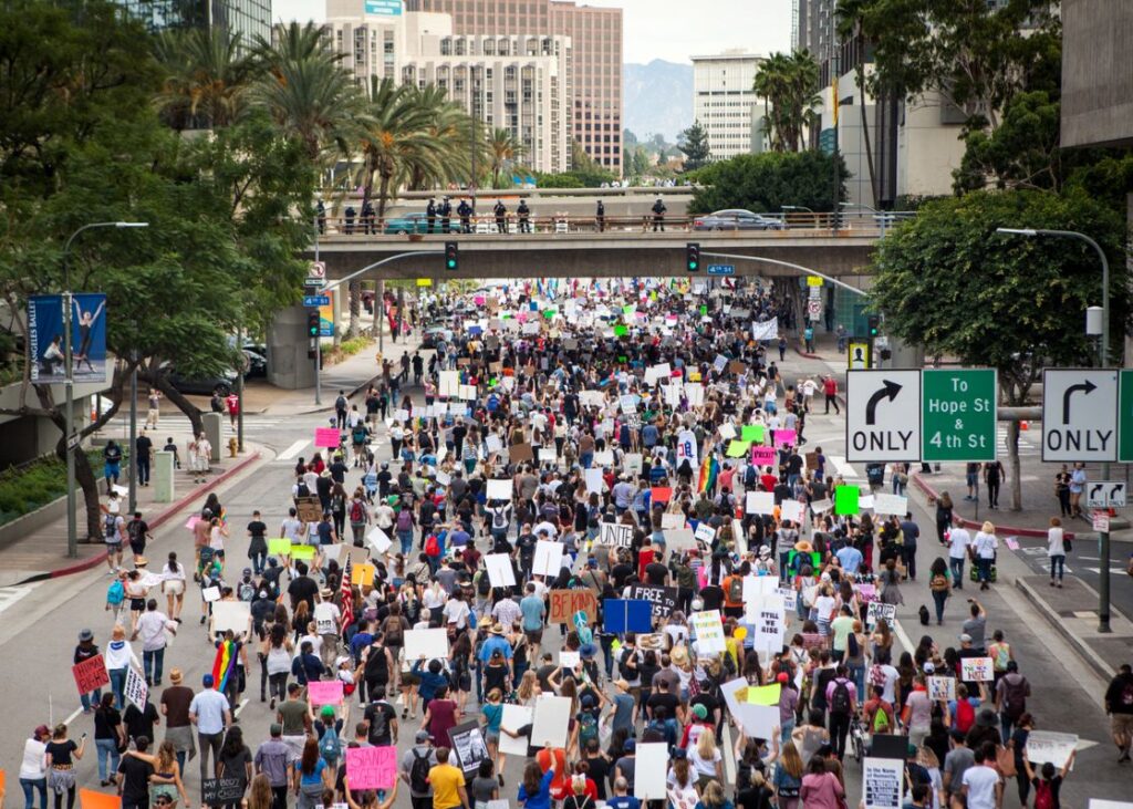 No Kings protests — dense crowd filling a downtown U.S. avenue