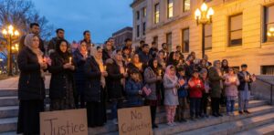 Afghans in the US gathered in a peaceful vigil outside a U.S. city hall, holding candles and American flags after the D.C. shooting.